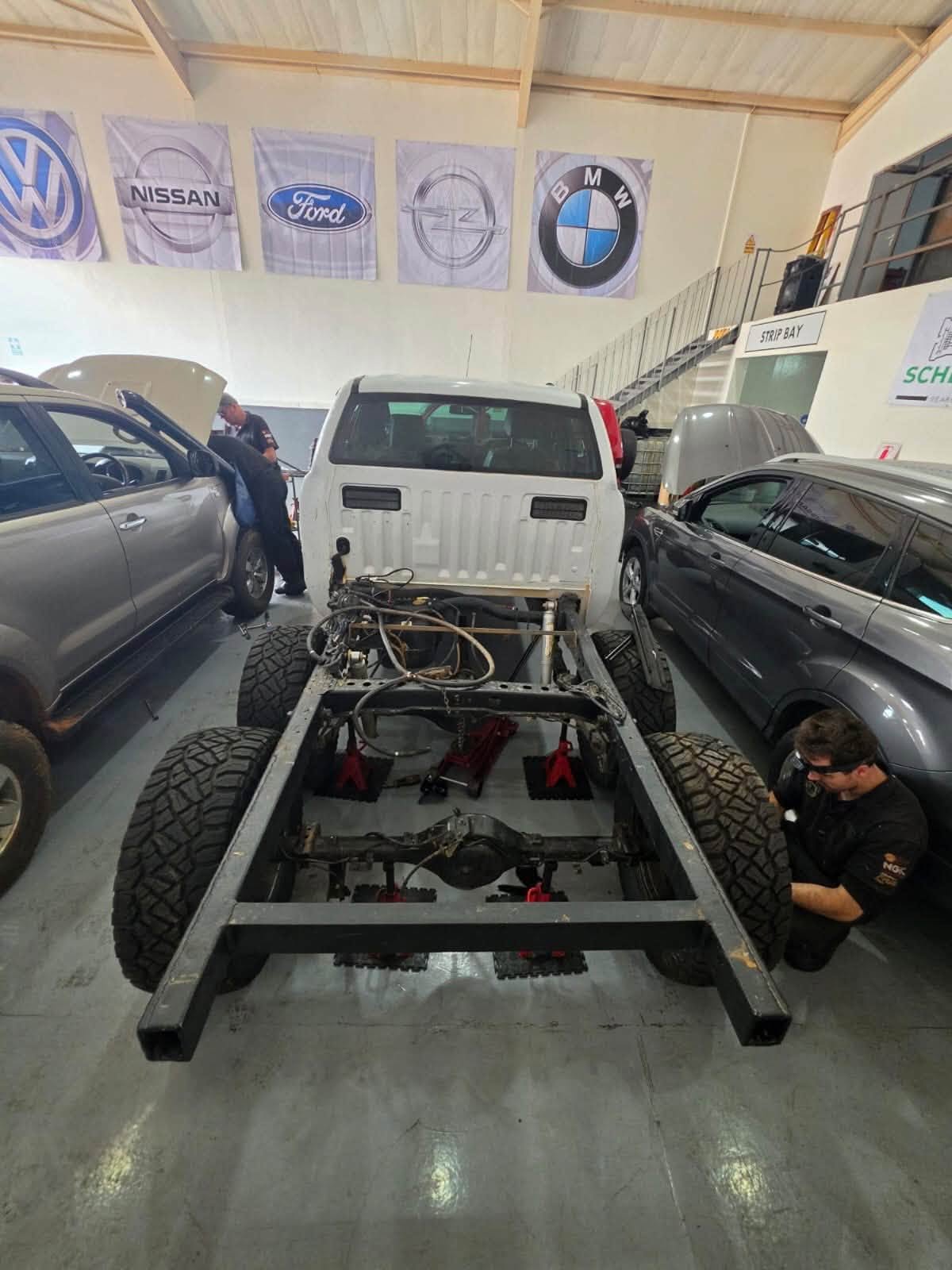The Scheün team carrying out mechanical work on a vehicle in the workshop